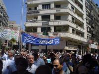 pro mubarak posters in the background